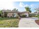 Inviting single-story home featuring a well-manicured lawn and charming curb appeal at 10841 Casa Grande Ave, Port Richey, FL 34668
