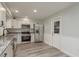 Renovated kitchen featuring stainless steel appliances, white cabinets, and modern flooring at 10841 Casa Grande Ave, Port Richey, FL 34668