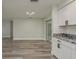 Open living room with wood floors and sliding glass door to the exterior at 10841 Casa Grande Ave, Port Richey, FL 34668