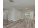 Open-concept living room with sliding glass doors, light gray walls and modern flooring at 10841 Casa Grande Ave, Port Richey, FL 34668