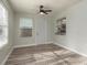 Sunroom with ceiling fan, windows, wood floors and exterior door at 10841 Casa Grande Ave, Port Richey, FL 34668