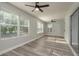 Sunroom with ceiling fans, windows, and wood floors at 10841 Casa Grande Ave, Port Richey, FL 34668