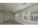 Bright sunroom with wood floors, ceiling fan and glass sliding doors to backyard at 10841 Casa Grande Ave, Port Richey, FL 34668