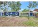 The spacious backyard with patio, mature trees, and enclosed porch at 1115 45Th N St, St Petersburg, FL 33713