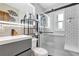 Modern bathroom featuring a glass-enclosed shower, gray vanity, and sleek fixtures at 1115 45Th N St, St Petersburg, FL 33713