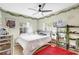 Comfortable bedroom with leafy wall decor, ample natural light, and ceiling fan at 1115 45Th N St, St Petersburg, FL 33713