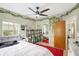 Bedroom featuring leafy wall decor, mirrored closet doors, ceiling fan, and a large red area rug at 1115 45Th N St, St Petersburg, FL 33713