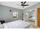 Bright bedroom featuring a ceiling fan, window, and mirrored closet doors at 1115 45Th N St, St Petersburg, FL 33713