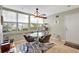 Cozy dining room with a round table, stylish chairs, large windows, and tile flooring at 1115 45Th N St, St Petersburg, FL 33713