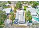 Birds eye view of a well-maintained property featuring mature palms, shed, patio seating, and fenced yard and in-ground pool at 112 11Th Ave, Indian Rocks Beach, FL 33785
