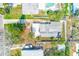 Birds eye view of a well-maintained property featuring mature palms, shed, patio seating, and fenced yard at 112 11Th Ave, Indian Rocks Beach, FL 33785
