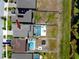 Aerial view of a backyard featuring a pool, lounge area, fire pit, and green space, adjacent to water at 11320 Chilly Water Ct, Riverview, FL 33569