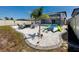 Backyard firepit area with Adirondack chairs and kayaks near the screened pool enclosure at 11320 Chilly Water Ct, Riverview, FL 33569