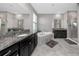 This elegant bathroom features dual sinks, granite countertops, a tub, and a glass-enclosed shower at 11320 Chilly Water Ct, Riverview, FL 33569