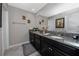 Elegant bathroom featuring granite countertops, decorative fixtures and a large mirror at 11320 Chilly Water Ct, Riverview, FL 33569