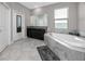 This bathroom features dual sinks, a tub, and a large mirror, offering a great space at 11320 Chilly Water Ct, Riverview, FL 33569