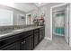 Bathroom featuring a dual sink vanity with granite countertops, and a separate tub at 11320 Chilly Water Ct, Riverview, FL 33569