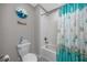 Cozy bathroom featuring a white shower/tub combo with seashell-themed shower curtain at 11320 Chilly Water Ct, Riverview, FL 33569
