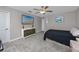 Comfortable bedroom features a ceiling fan, a dresser and a mounted flat screen tv at 11320 Chilly Water Ct, Riverview, FL 33569