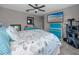 Comfortable bedroom with light-colored walls, a ceiling fan, and a large TV at 11320 Chilly Water Ct, Riverview, FL 33569