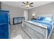 Comfortable bedroom features a bed, ceiling fan and decor with a nautical theme at 11320 Chilly Water Ct, Riverview, FL 33569