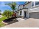 Beautiful two-story home featuring a covered entryway with stone accents and lush landscaping at 11320 Chilly Water Ct, Riverview, FL 33569