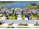 Street view of well-maintained homes with manicured lawns and landscaped front yards in a lakeside community at 11320 Chilly Water Ct, Riverview, FL 33569
