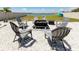 Backyard fire pit overlooking a scenic lake, surrounded by cozy seating at 11320 Chilly Water Ct, Riverview, FL 33569