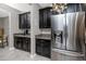 Kitchen area showcasing dark cabinetry, granite countertops, and a stainless steel refrigerator at 11320 Chilly Water Ct, Riverview, FL 33569