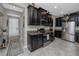 Modern kitchen featuring granite countertops, stainless steel appliances and sleek black cabinets at 11320 Chilly Water Ct, Riverview, FL 33569