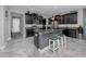 Kitchen featuring dark cabinets, granite counters, stainless appliances, and island seating at 11320 Chilly Water Ct, Riverview, FL 33569