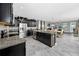 Spacious kitchen with stainless steel appliances, dark cabinets, and a large center island at 11320 Chilly Water Ct, Riverview, FL 33569