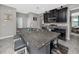 Spacious kitchen island with barstool seating and sleek, dark cabinetry at 11320 Chilly Water Ct, Riverview, FL 33569