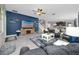 Living room with entertainment center, fan, and leather sofa at 11320 Chilly Water Ct, Riverview, FL 33569