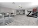 Large living room with a ceiling fan, exercise equipment, and a gray sectional sofa at 11320 Chilly Water Ct, Riverview, FL 33569