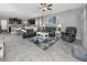 Open concept living room with dark furniture and an adjacent kitchen at 11320 Chilly Water Ct, Riverview, FL 33569