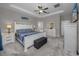 Spacious bedroom with a large bed, ceiling fan, and neutral color scheme at 11320 Chilly Water Ct, Riverview, FL 33569