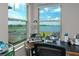 Bright office nook with a desk setup, windows and a beautiful view of the lake at 11320 Chilly Water Ct, Riverview, FL 33569