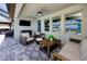 Relaxing outdoor patio area with comfortable wicker furniture and a ceiling fan at 11320 Chilly Water Ct, Riverview, FL 33569