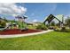 Community playground area featuring play equipment, mulch, a sidewalk, green space and a shade structure at 11320 Chilly Water Ct, Riverview, FL 33569