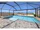 Inviting screened-in pool and spa overlooking a serene lake at 11320 Chilly Water Ct, Riverview, FL 33569