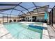 Large screened-in pool with an attached spa and outdoor seating area at 11320 Chilly Water Ct, Riverview, FL 33569