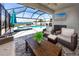 Screened outdoor living area with pool, spa, ceiling fan, and television at 11320 Chilly Water Ct, Riverview, FL 33569