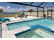 Backyard pool with a spa, overlooking a picturesque lake, and a fire pit area at 11320 Chilly Water Ct, Riverview, FL 33569