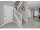 Carpeted staircase with white railing and adjacent doors at 11320 Chilly Water Ct, Riverview, FL 33569