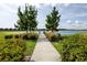 Scenic community walking path leading to a lake with lush landscaping and a charming wooden dock at 11320 Chilly Water Ct, Riverview, FL 33569