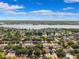 An aerial view showcasing a residential area near a lake and waterway on a beautiful day at 11510 92Nd Way, Largo, FL 33773