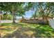 A spacious backyard surrounded by a white vinyl fence and mature trees at 11510 92Nd Way, Largo, FL 33773