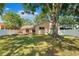 A lovely backyard with a well-maintained lawn, wooden deck and mature tree providing ample shade at 11510 92Nd Way, Largo, FL 33773
