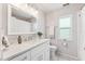 Bathroom featuring a white vanity with marble countertops, chrome fixtures, and a window at 11510 92Nd Way, Largo, FL 33773